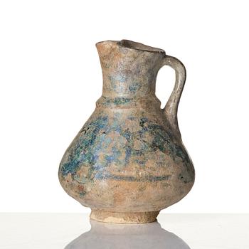 A turquoise-glazed Keshan jug, Persian, 13th century.