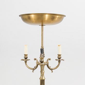 A 1940s brass floor lamp.