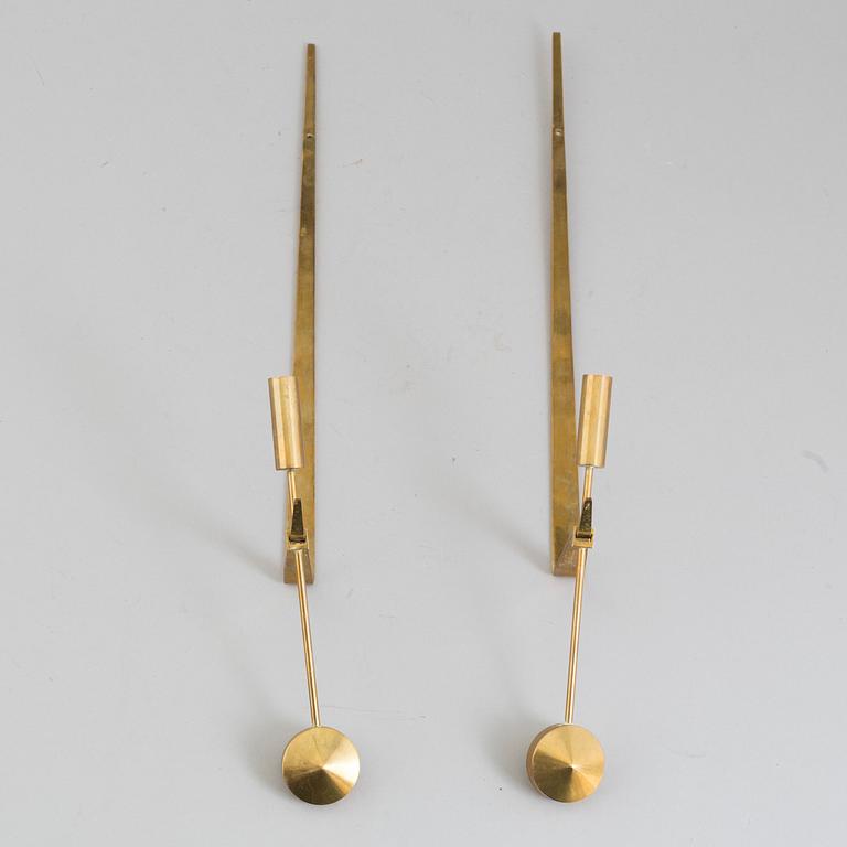 A pair of brass 'Pendeln' candleholders by Pierre Forsell, Skultuna.