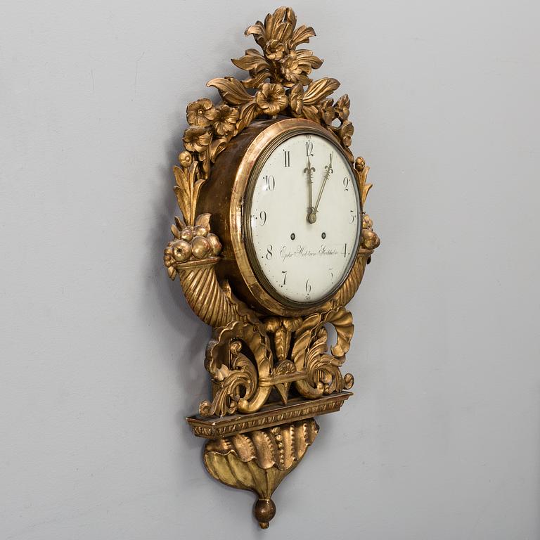 A late Gustavian gilt wood wall clock by Ephraim Hedström (active 1808-1818), Stockholm.