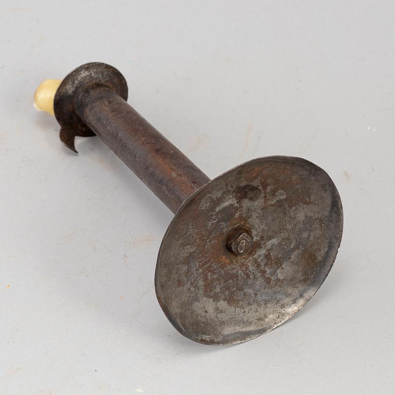 An 18th century tinplate candlestick.