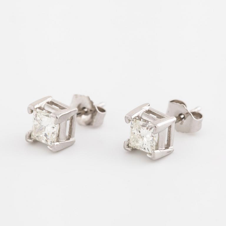 A pair of princess cut diamond earrings.