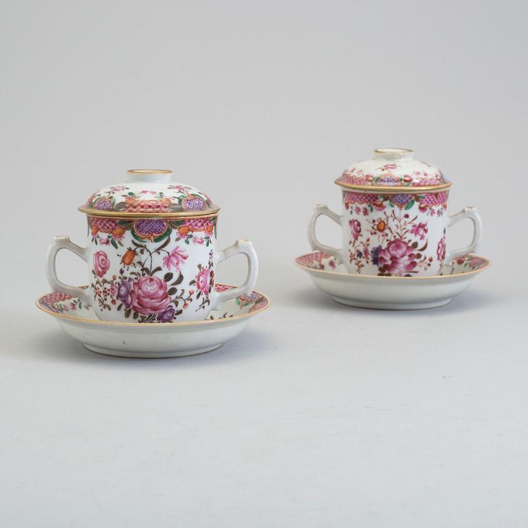 A pair of famille rose cups with covers and stands, Qing dynasty, Qianlong (1736-95).