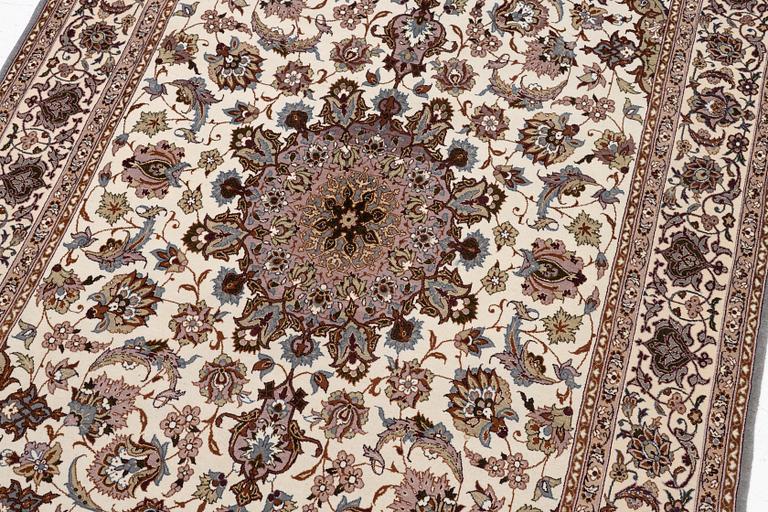 A semi-antique Isfahan rug, central Persia, signed Ghaffarian, c. 180 x 112 cm.