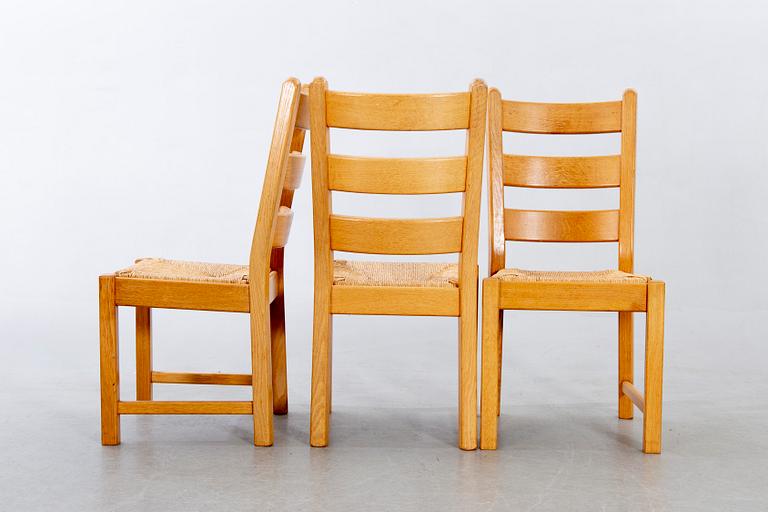 A set of four wicker and oak 1970s chairs.