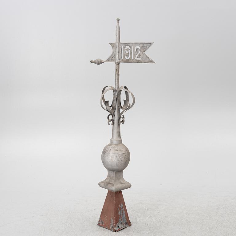 Tower spire with weather vane dated 1912.
