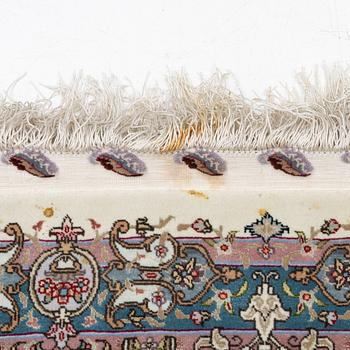 A Tabriz, carpet, 310 x 195 cm. signed.