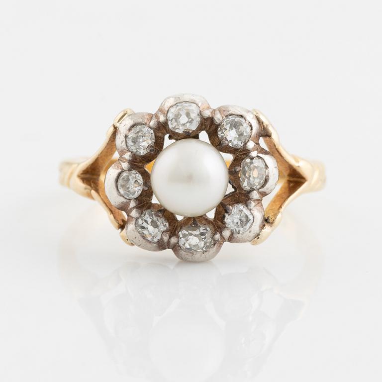 An 18K gold ring and silver set with a pearl and old-cut diamonds.