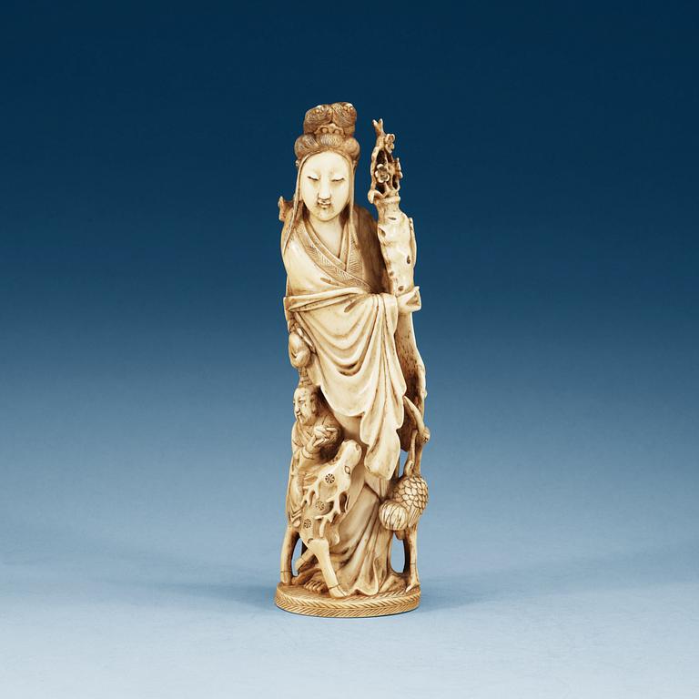 A carved ivory figure of a lady with a deer, crane and a flower vase, late Qing dynasty, 19th Century.
