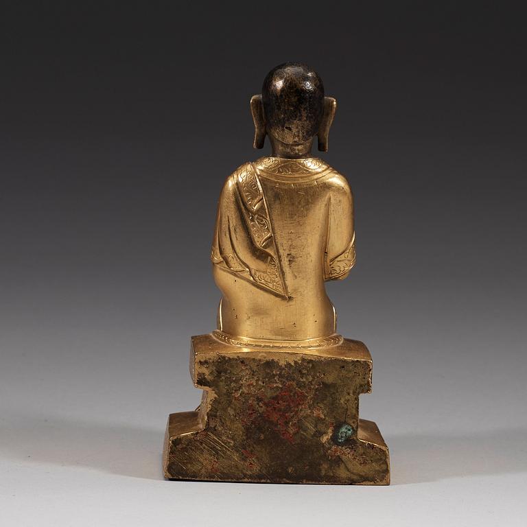 A part-gilt bronze figure of a Lohan, presumably Kalika, Tibeto-Chinese, 18th Century.