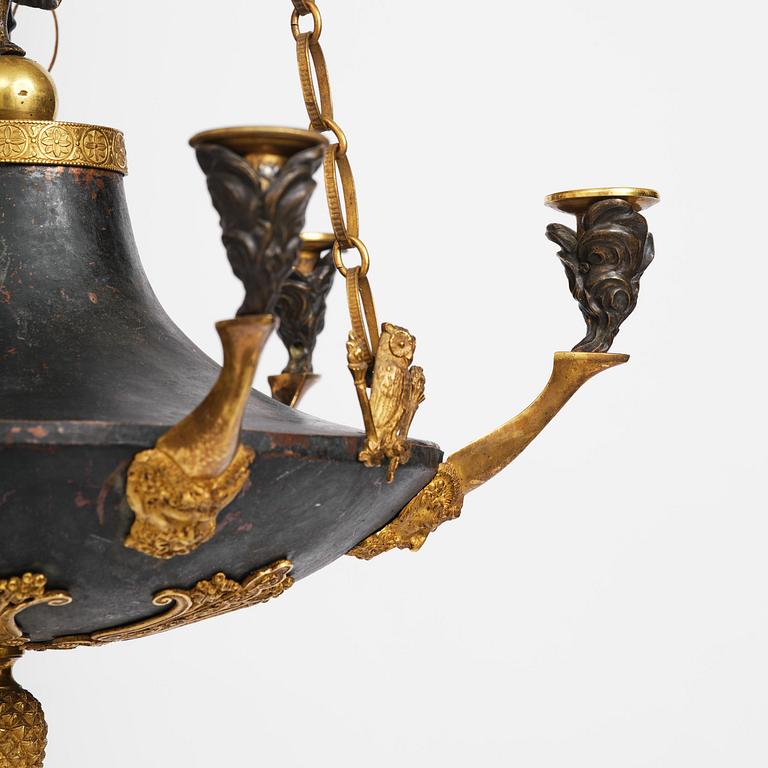 A patinated and ormolu six-light Empire chandelier, Stockholm, first part 19th century.