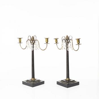 A pair of wooden candelabras, around 1900.