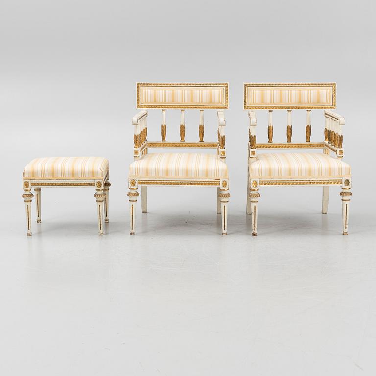 A pair of late Gustavian-style open armchairs and a stool, circa 1900.