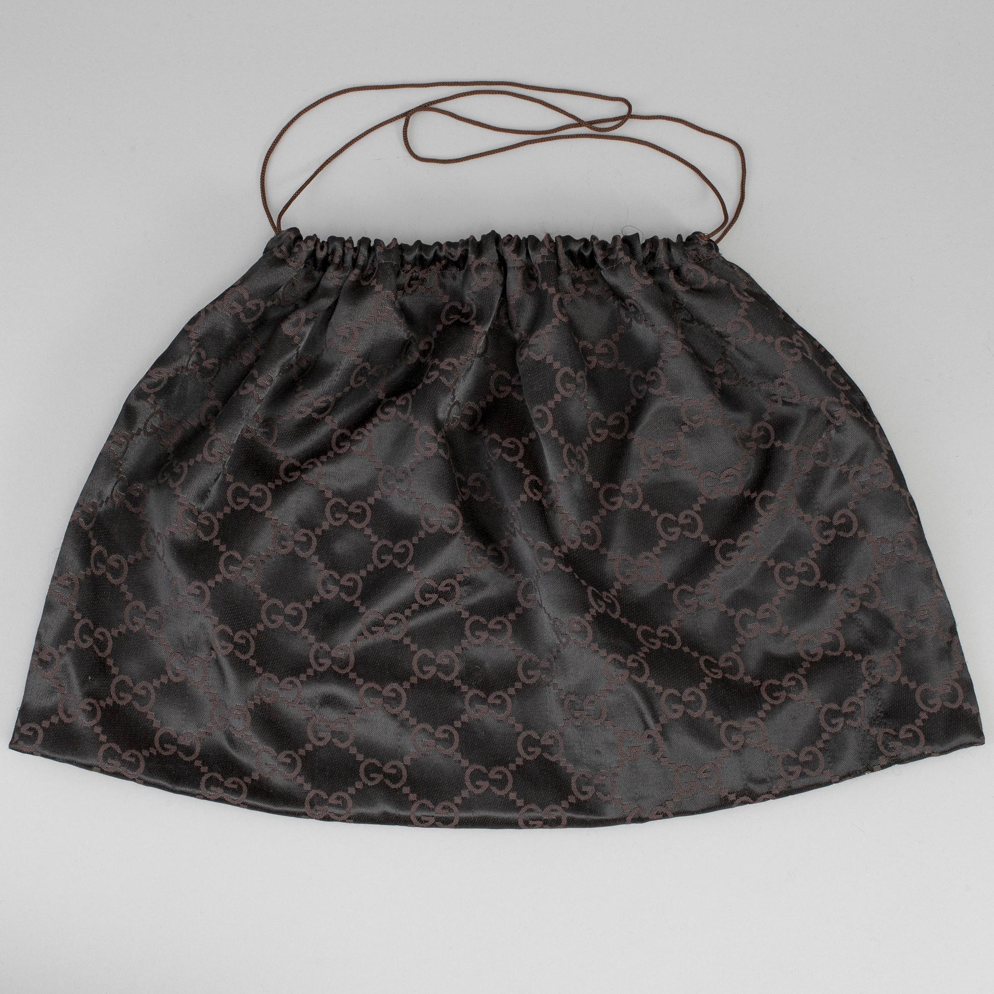 GUCCI, a canvas handbag.