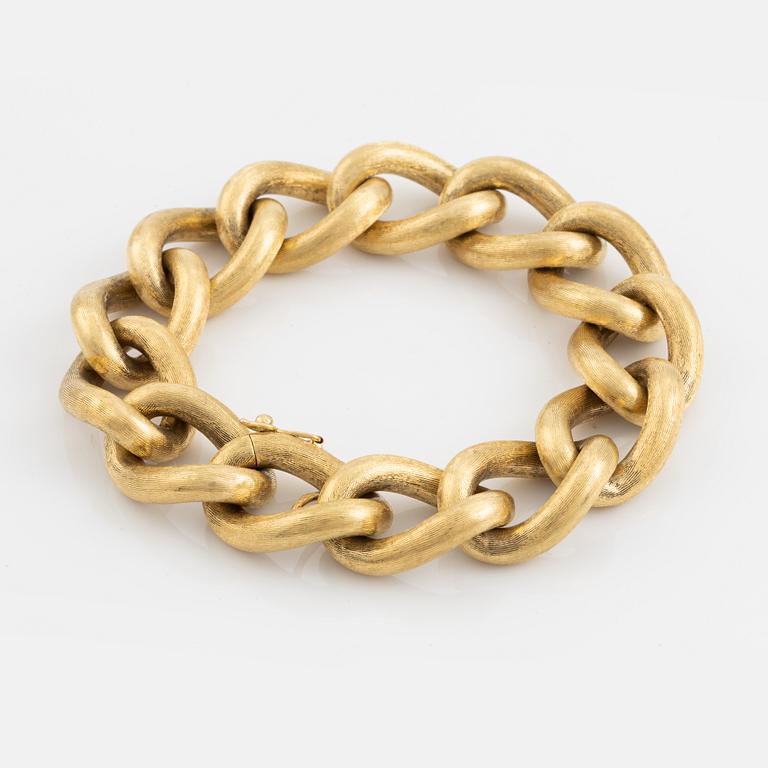 An 18K gold bracelet.
