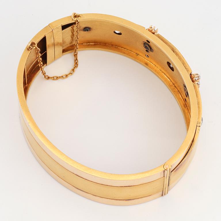 An 18K gold bracelet set with old-cut diamonds.