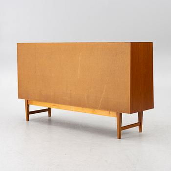A mid20th century teak-veneered sideboard.