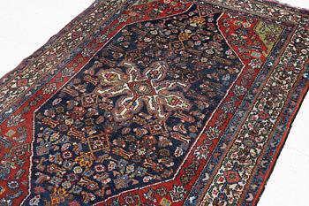 An oriental, semi-antique rug, c. 195 x 130 cm.