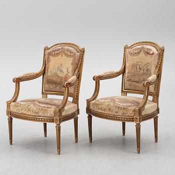 A pair of Louis XVI-style armchairs, late 19th century with 18th century fabric.