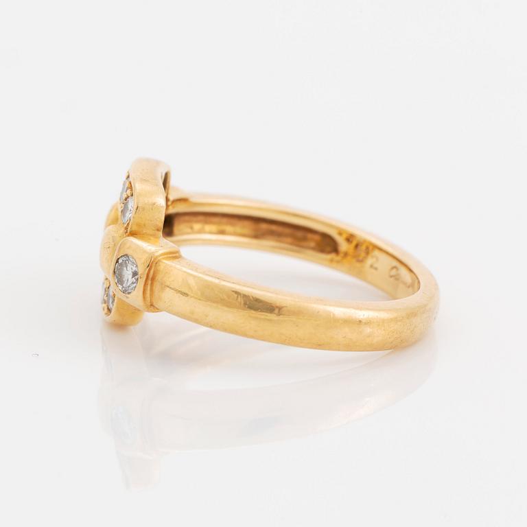An 18K gold Cartier ring set with round brilliant-cut diamonds.
