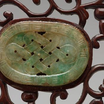 A set of four carved nephrite objects on a wooden frame, Qing dynasty (1664-1912).