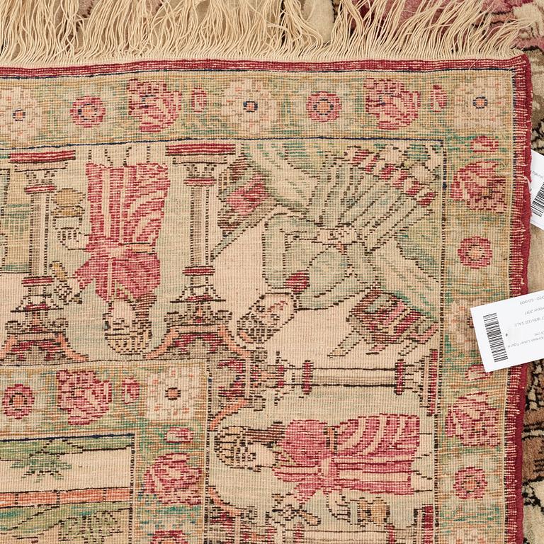 A RUG, an antique Kerman Laver figural, ca 212,5 x 141,5 cm.