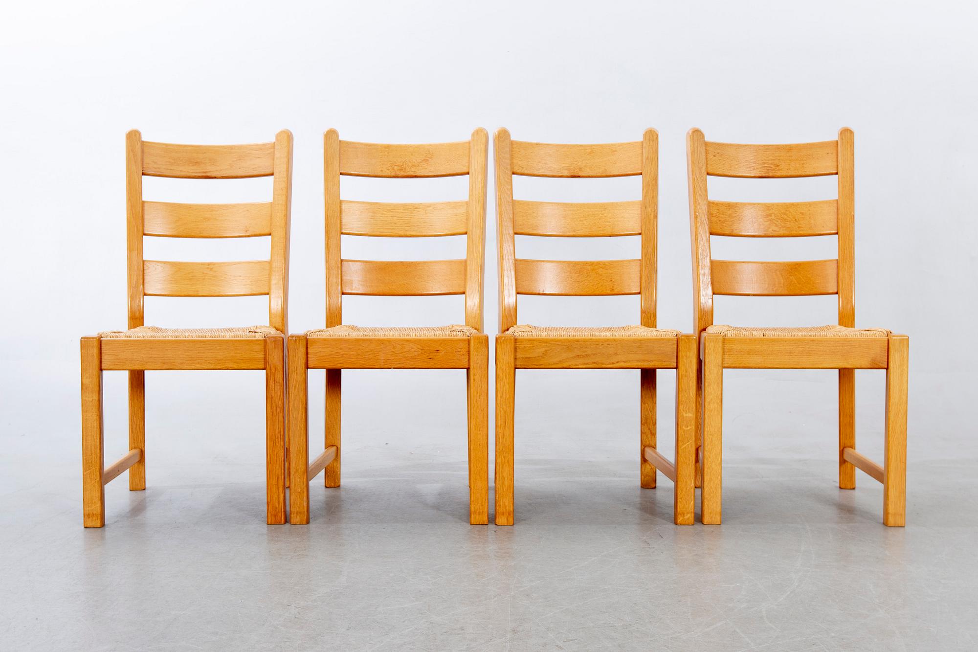 A set of four wicker and oak 1970s chairs.
