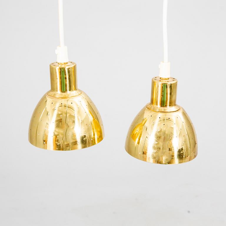 A pair of Hans-Agne Jakobsson brass ceiling pendants.