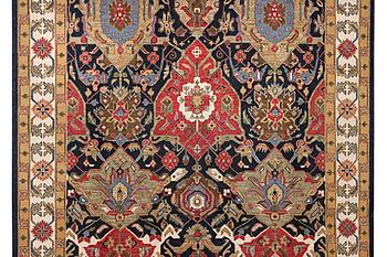 An oriental carpet with Mamluk design, c. 364 x 276 cm.