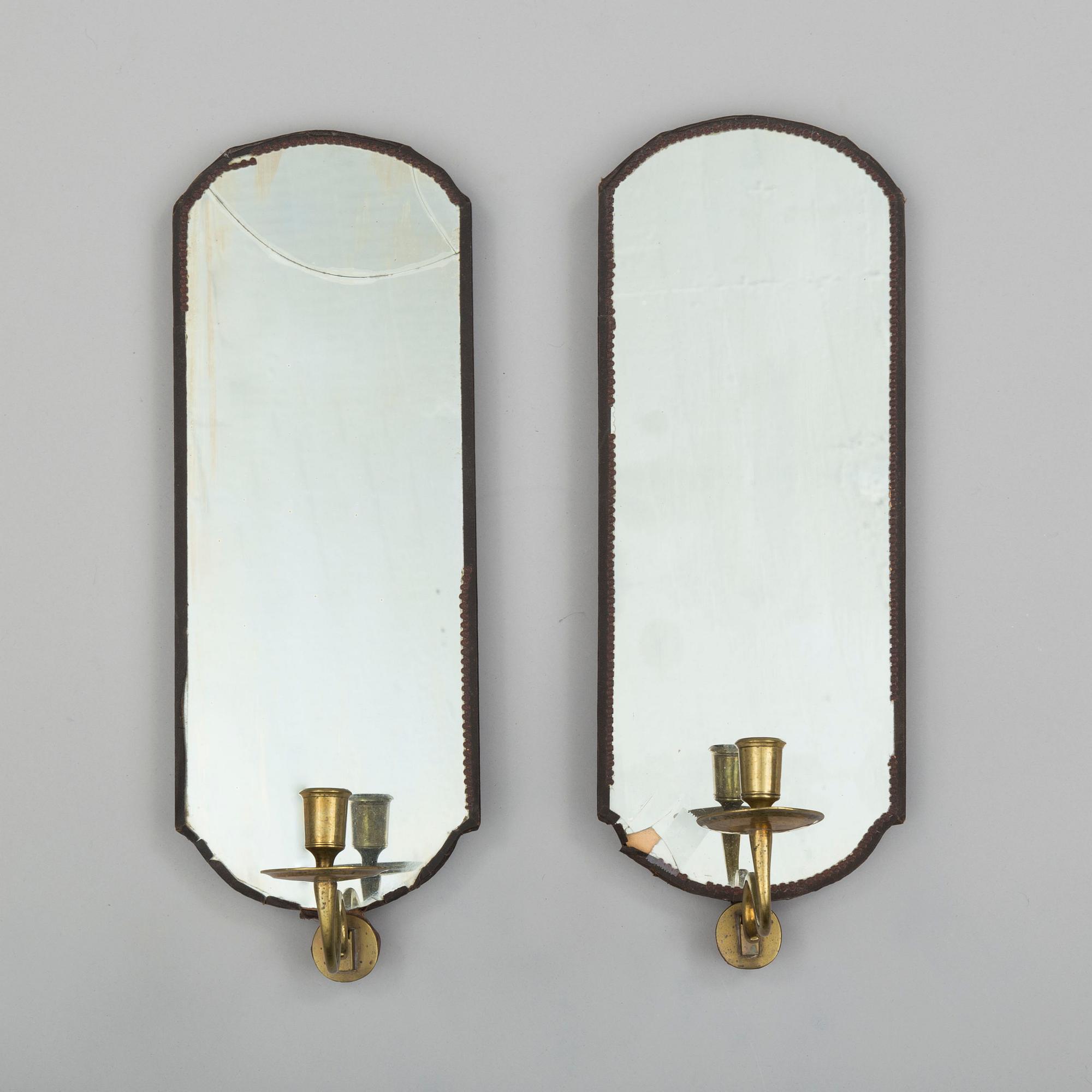 A pair of mirrors with candle sconces, partly 18th century.