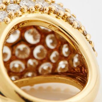 Cartier "Marrakech" an 18K gold bombé ring set with round brilliant-cut diamonds.