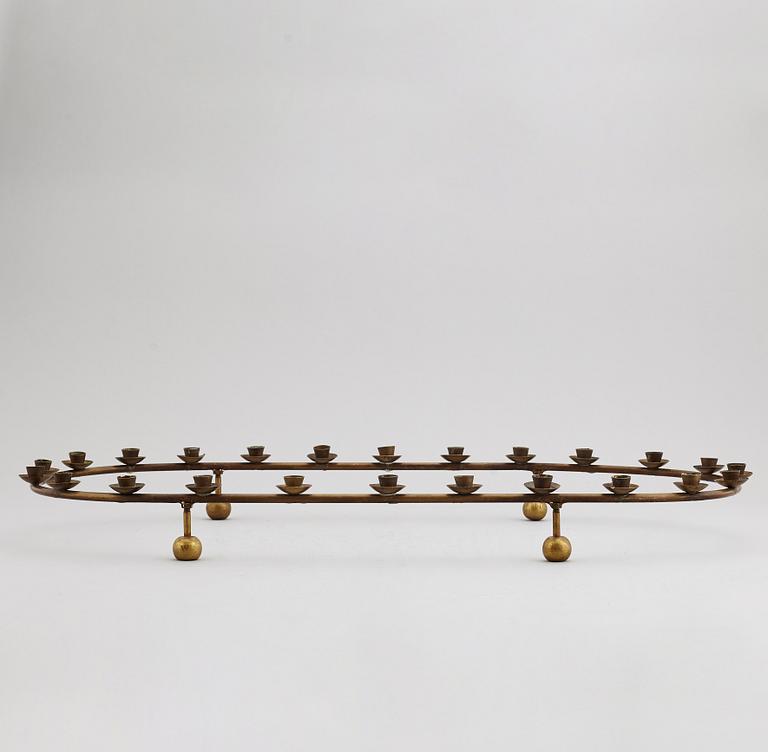 A mid 20th Century brass candle ring.