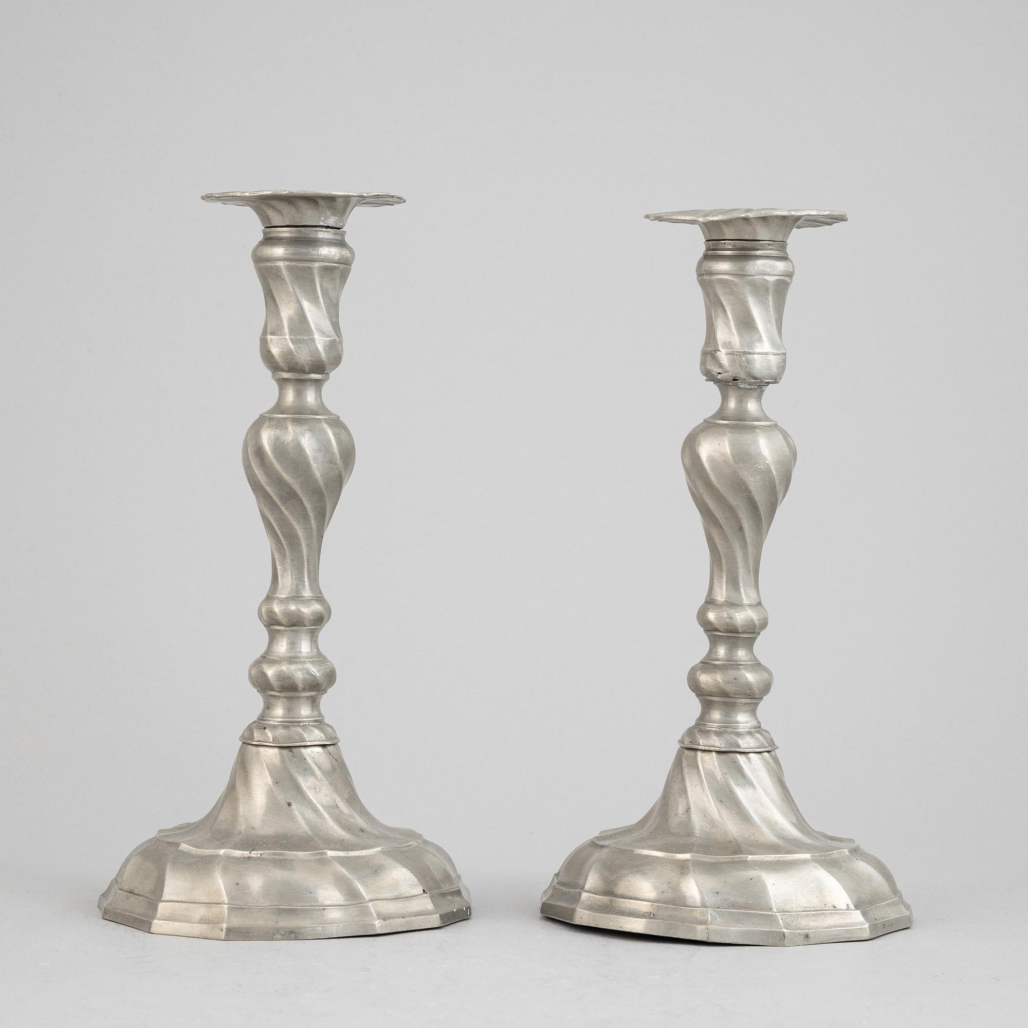A pair of rococo style pewter candlesticks, 19th Century.