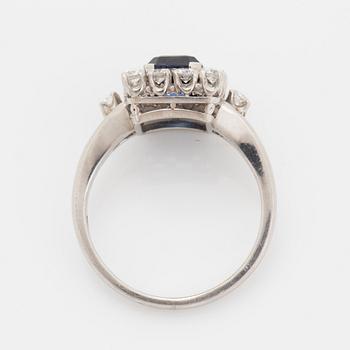 A platinum ring set with a faceted sapphire.