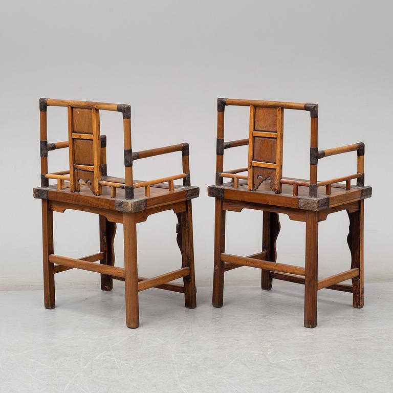 A pair of Chinese wooden armchairs, late 19th/early 20th century.