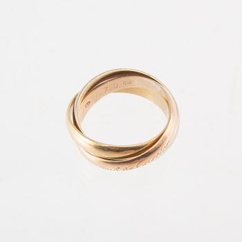 An 18K tri-coloured "Trinity" gold ring by Cartier.