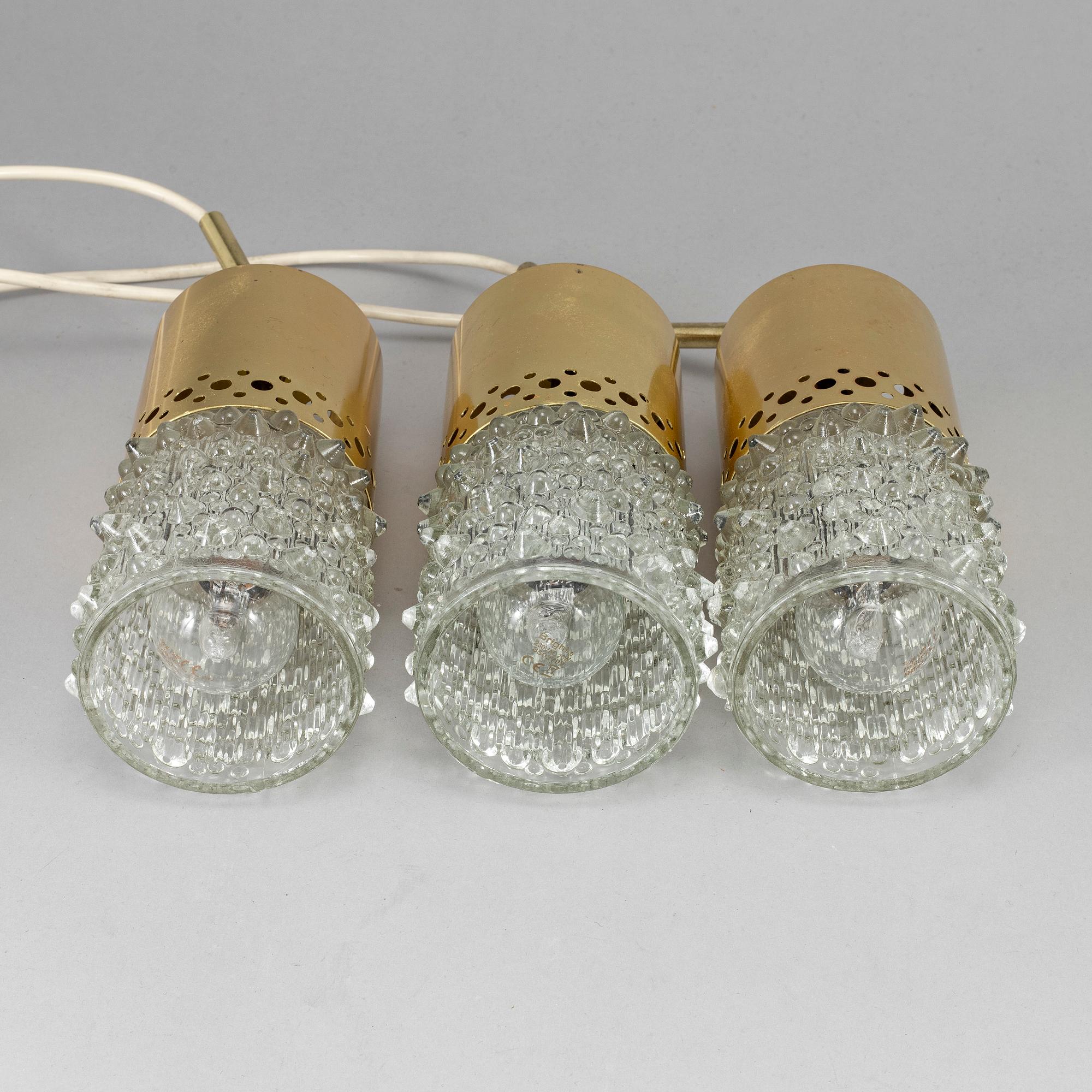 Three brass and glass pendant lights, 1960's.