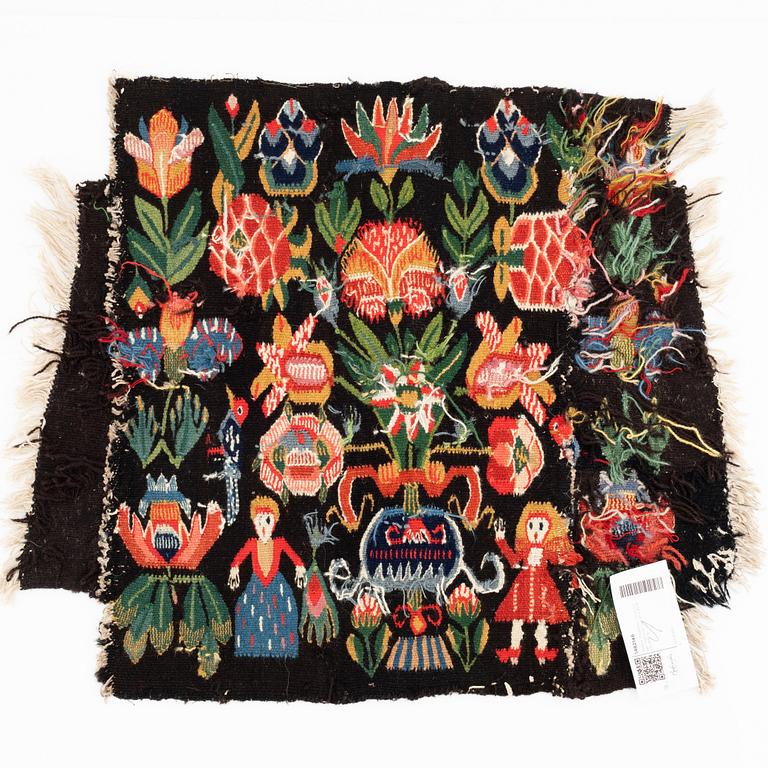 A fragment of a 19th century carrige cushion, "Urnor och par", tapestry weave, ca 50 x 45-55 cm.