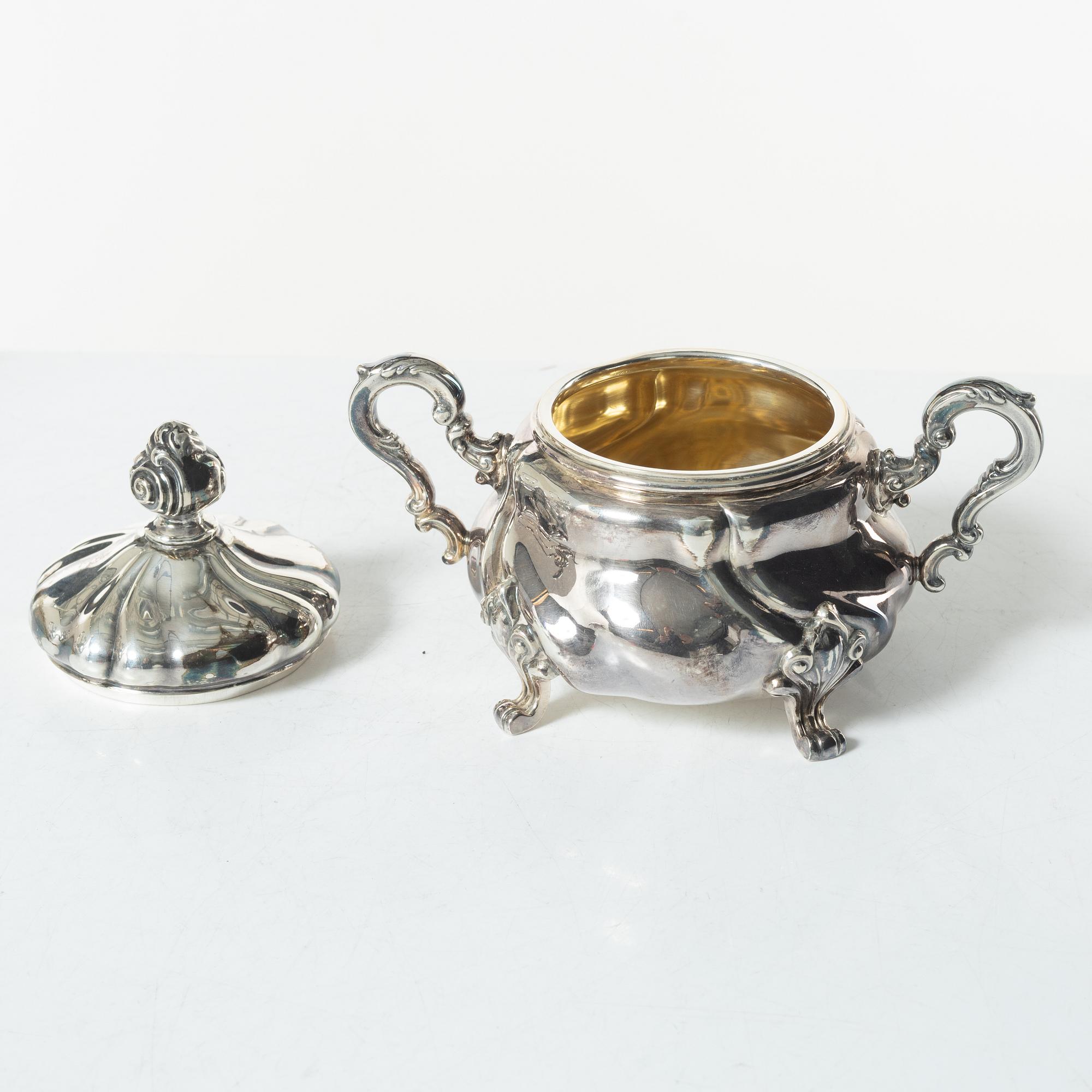 A Norwegian silver Rococo style coffee pot, cream jug, and sugar bowl, Norsk Filigransfabrikk, Oslo circa 1920.