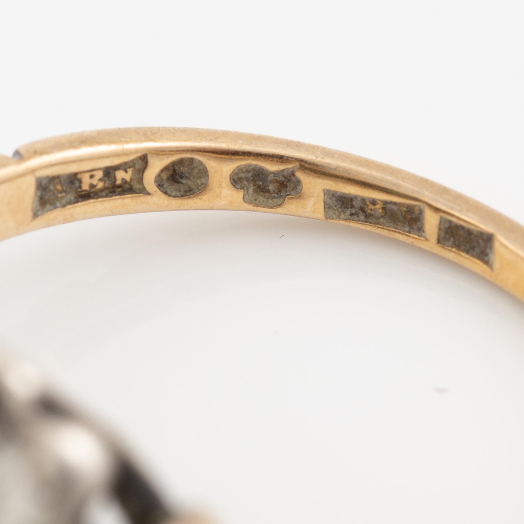 Ring 18K gold and silver set with old-cut diamonds and green stones.