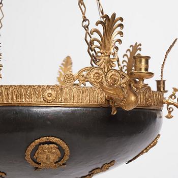 A presumably Russian Empire gilt and patinated bronze nine-branch chandelier, 19th century.