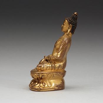 A gilt copper-alloy figure of Aksobhya Buddha, 15th/16th century, Tibet or Nepal.