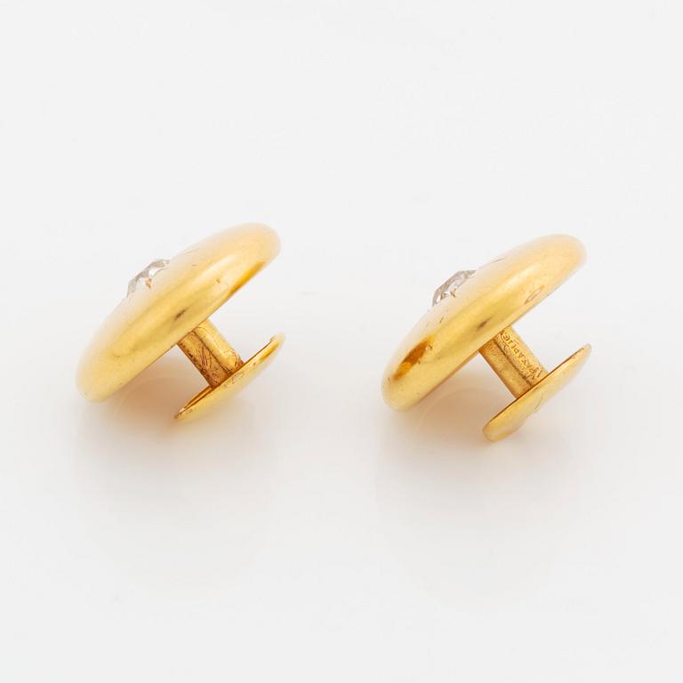 A pair of 18K gold cufflinks set with old-cut diamonds.