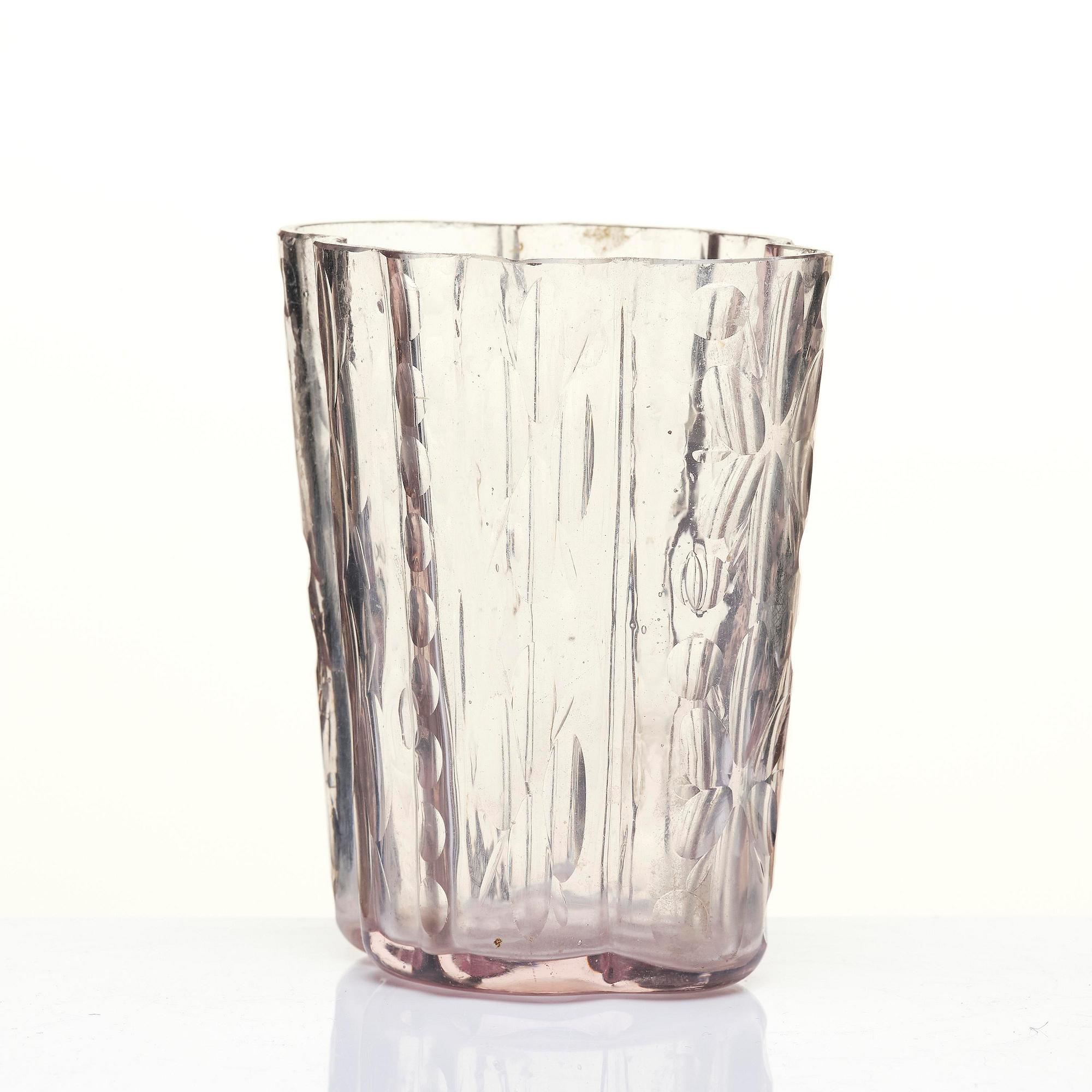 An amethyst coloured suger shaker and a cut glass goblet, 18th century.