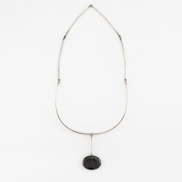 Vivianna Torun Bülow-Hübe, a pendant with chain, silver with a beach pebble, 1963.