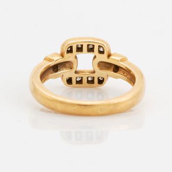 An 18K gold Cartier ring set with round brilliant-cut diamonds.