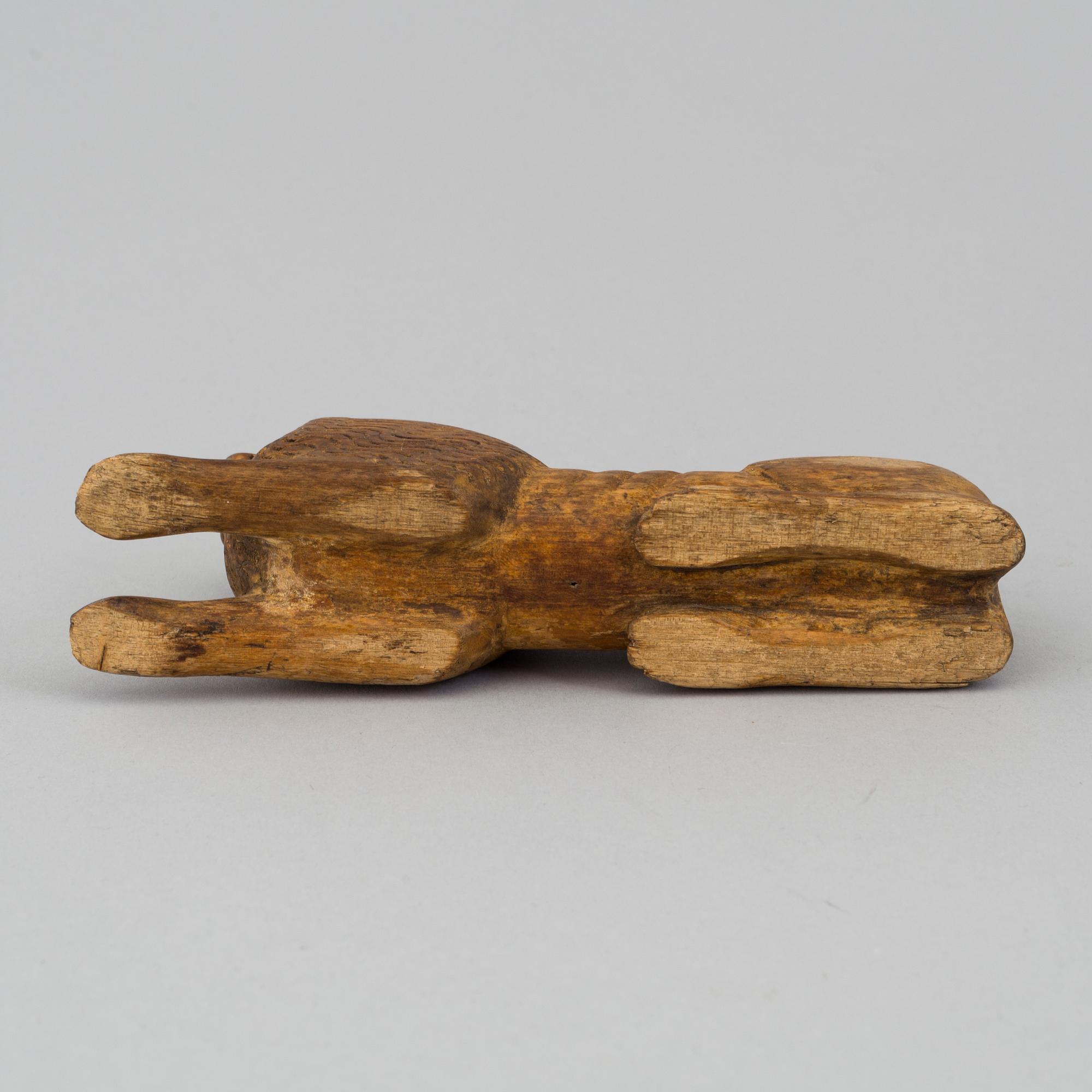 A carved wood sculpture of a lion from the 19th century.