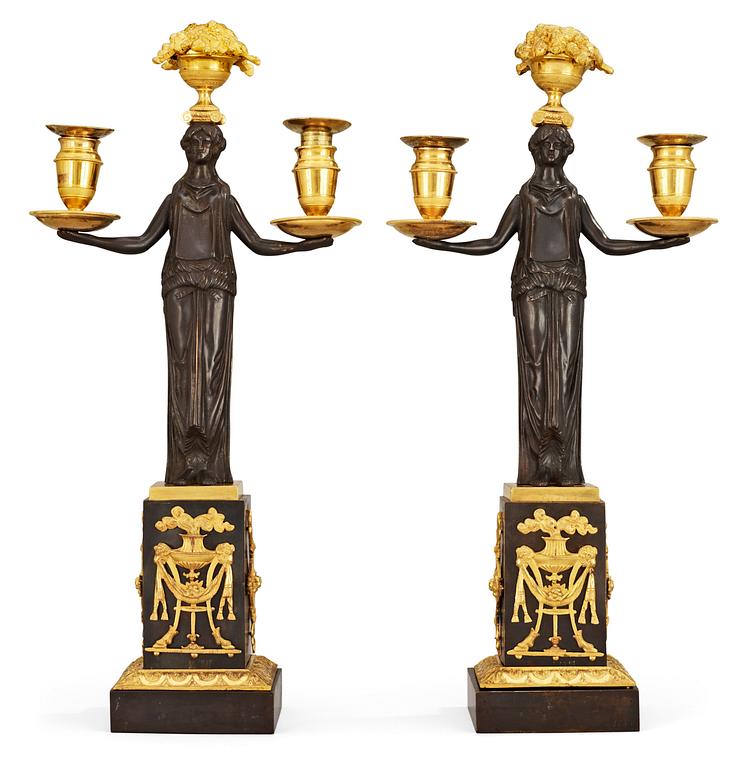 A pair of Empire early 19th c. two-light gilt and patinated bronze candelabra.