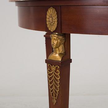 An empire-style table, early 20th century.