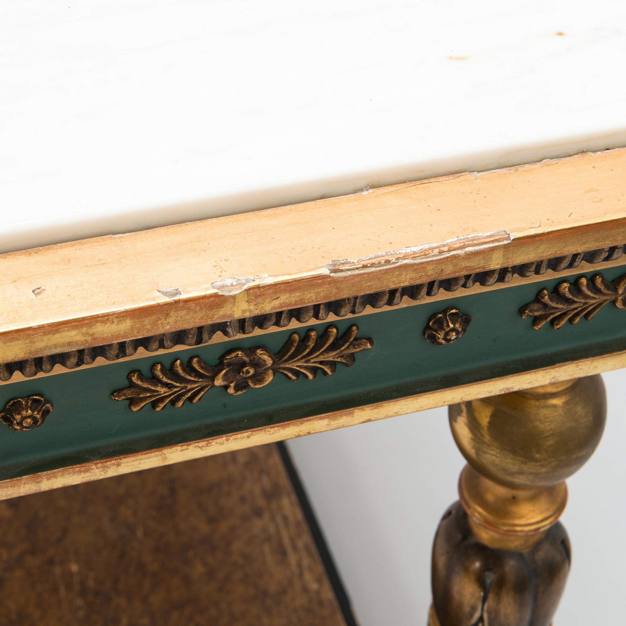An early 20th century mirror with console table in late Gustavian style.